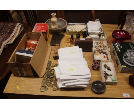 A collection of small china and glass ornaments; various linen and textiles; a set of brass hooks in the form of a plough tea
