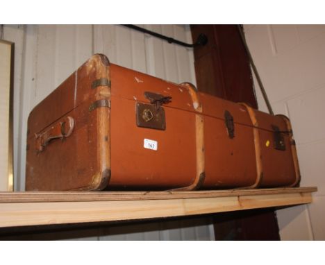 A large wooden bound travelling trunk