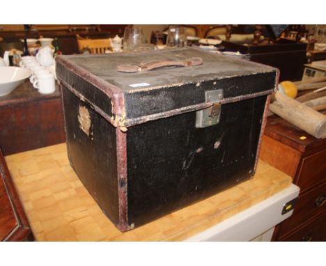 A small black canvas and leather bound travelling trunk 