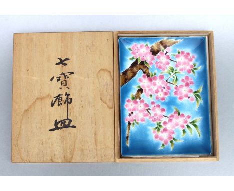 A Japanese Tutanka enamel rectangular dish decorated with cherry blossom on a blue ground, 24cms wide, in original box.