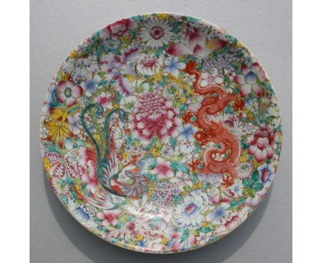 A Chinese millifiori charger decorated with a red dragon and phoenix, red seal mark to the underside, 34cms diameter.Conditio