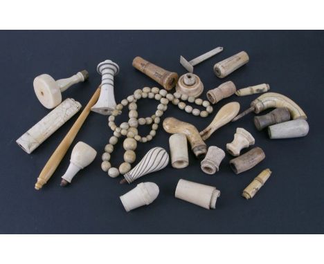 A string of late 19th century graduated ivory beads, together with ivory and bone walking stick handles and other items.