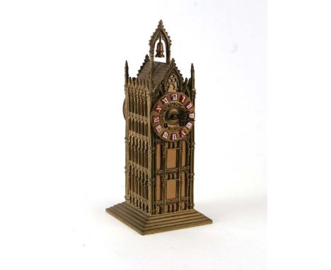 A brass Gothic tower mantle clock, 33cms high.