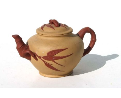 A Chinese Yixing pottery teapot decorated bamboo with impressed seal mark to the underside. 10cm high