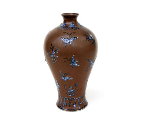 A Chinese Meiping vase decorated enamels butterflies and flowers on  brown ground with an impressed seal mark to the undersid