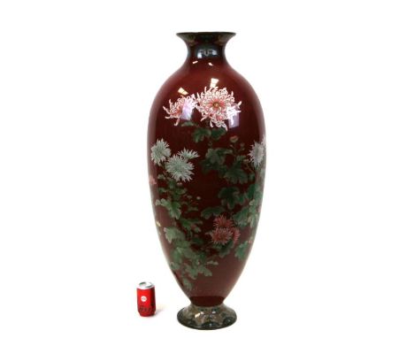 A very large Japanese cloisonné floor vase decorated with chrysanthemums on a ruby red ground, 39.5ins (101cms high). Conditi