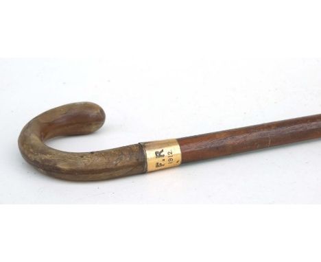 A hardwood walking stick with horn handle and gold plated collar, 91cms long.