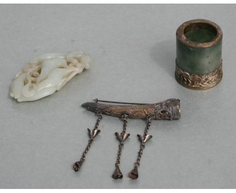 A Chinese jade / hardstone archers ring with later applied metal mounts, 3cms diameter; together with a metal finger guard an