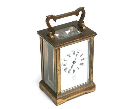 A brass four-pillar carriage time piece, the white enamel dial with Roman numerals, signed 'Dent Pall Mall London', 11cms hig