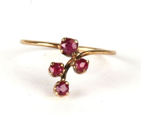 A 9ct gold ring set with four red stones, approx UK size 'K'.