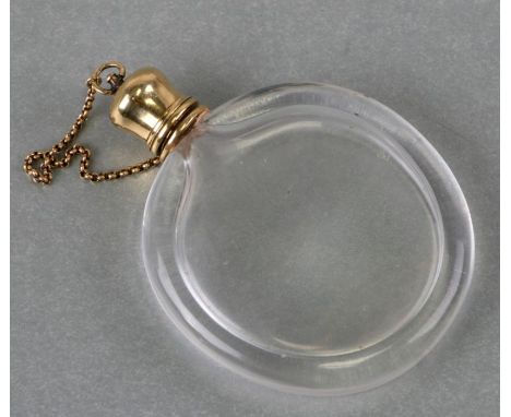 An antique French yellow metal mounted glass scent bottle, indistinct mark (tests as 18ct), the lid attached with a chain, 7.