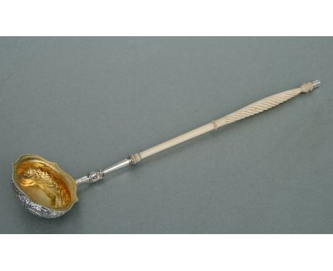 A George IV Scottish silver gilt punch ladle, the shaped silver gilt bowl with chased floral and scroll decoration, the styli