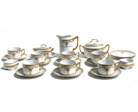 A Czechoslovakian Art Deco part tea service comprising eight cups and saucers, milk jug, sugar bowls, and two salts.