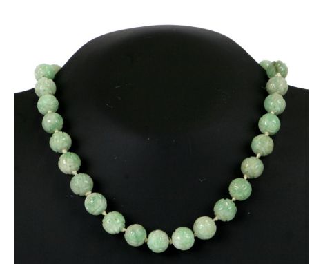 A carved jade / hardstone bead necklace with yellow metal clasp.