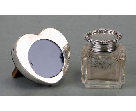 A silver heart shaped photo frame, London 1928,  6.5cm wide together with a silver topped glass inkwell. (2)