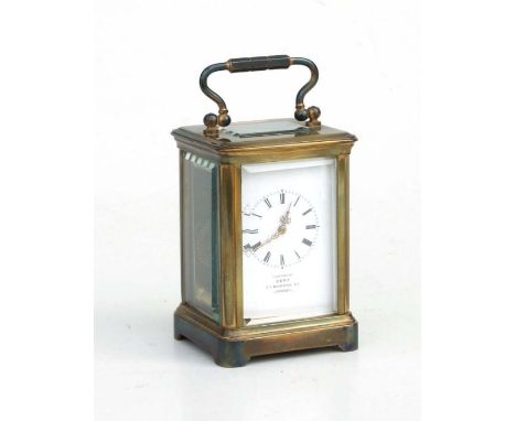A miniature brass cased carriage timepiece, the white enamel dial with Roman numerals and marked 'Examined by Dent, 33 Cocksp