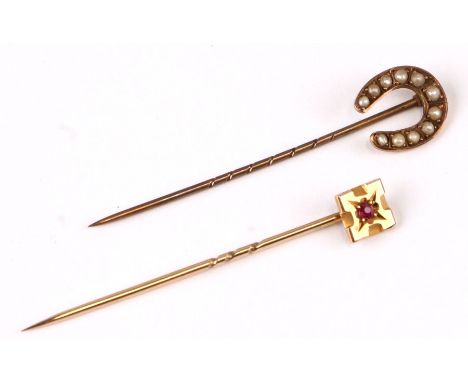 A 15ct gold stick pin set with a single ruby; together with a 9ct gold stick pin set with seed pearls (2).