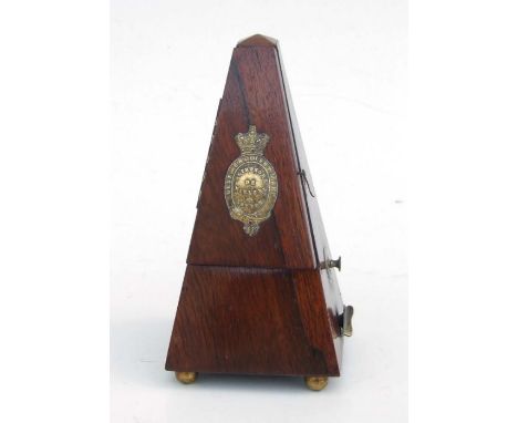 An early 20th century metronome by Maezel of London, in a walnut case, 22cms high. 