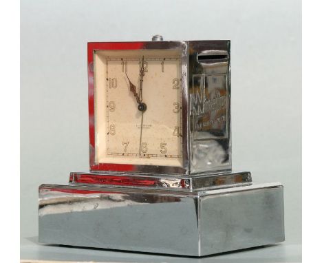 An Art Deco Winterthur Leben-Vie combination alarm clock / money box, in a chrome case, 12cms high.