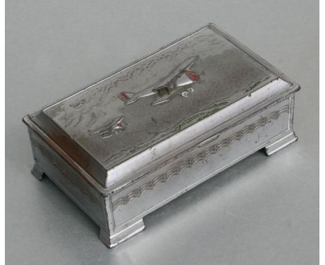 A chrome plated rectangular table-top cigarette box, the lid decorated with three bi-planes with traces of enamel decoration,