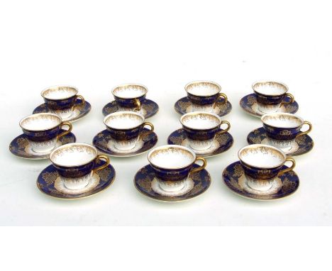 A set of eleven Coalport cabinet tea cups and saucers decorated with gilt swags on a dark blue and white ground.