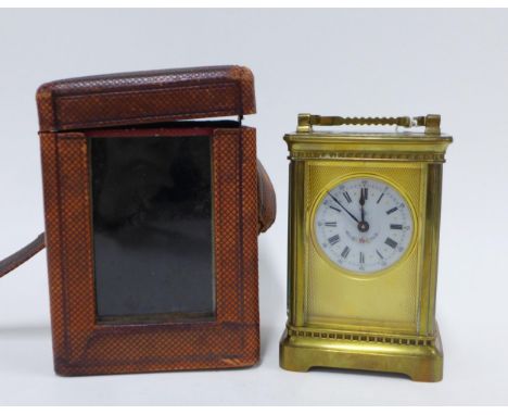 Brass and glass panelled carriage clock, black Roman numerals on a floral decorated dial, with leather case, 17cm including h