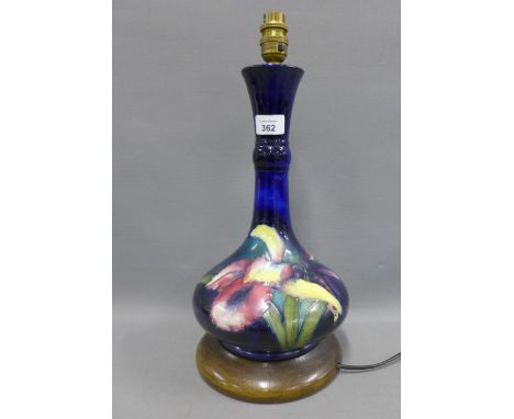 Moorcroft table lamp base, cobalt blue ground and tubeline decorated with Iris pattern, on a turned wooden base, height exclu