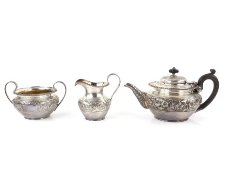 Victorian silver three piece tea service comprising teapot, cream jug and sugar bowl, with gadrooned and embossed floral deco