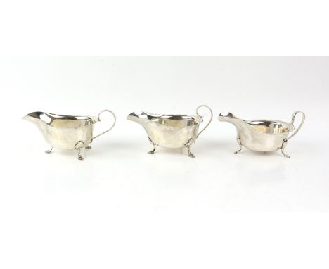 Pair of George VI silver sauceboats with serpentine rims on hoof feet, by Mappin & Webb, Sheffield, 1938/9, and another simil