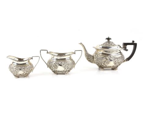 Victorian silver three piece tea service, comprising teapot, cream jug and sugar bowl with embossed scrolling decoration, gad