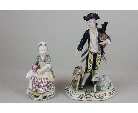 A Dresden porcelain figure of a pipe player wearing a blue tunic, crossed swords mark to base, 17cm, and another smaller figu