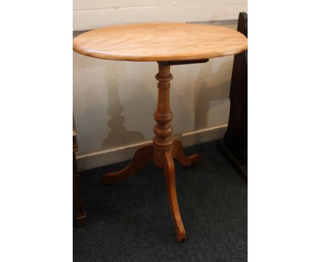 A satinwood oval occasional table on baluster support and tripod base