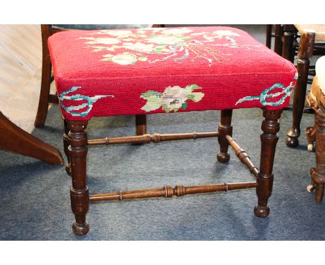 A tapestry top stool on turned legs with ball feet joined by stretcher rail, 66cm by 52cm by 49cm