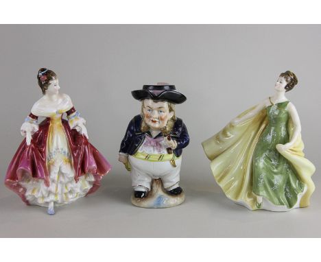 Two Royal Doulton figurines of ladies, Alexandra and Southern Belle, together with a Toby jug of gentleman with pipe, tallest