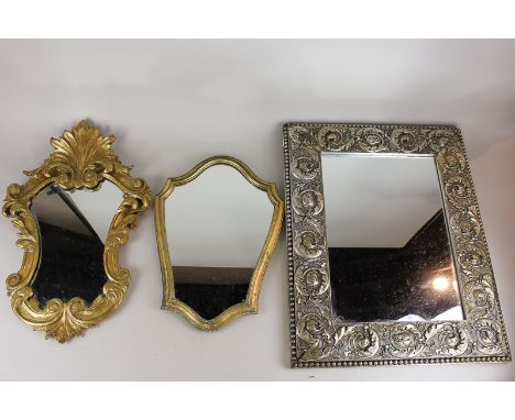 A gilt wood cartouche shaped wall mirror, 53cm high, a silver gilt rectangular wall mirror with fruiting buds and scroll bord