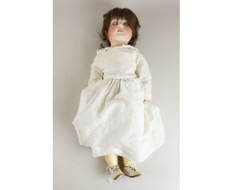A bisque head and shoulder doll, made in Germany incised on back, sleeping eyes and open mouth, with composite jointed limbs 