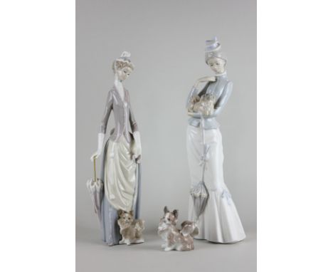 Two Lladro figures of ladies with dogs and another individual dog ornament, tallest 37.5cm high