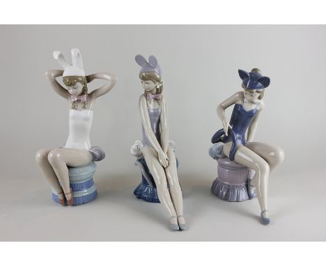 Three Lladro figures of dancers, one dressed as a mouse, another a rabbit and the other as a cat, tallest 27cm high