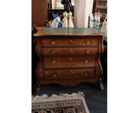 An 18th century Dutch walnut bombe commode, inlaid throughout with floral sprays and scrolls, shaped top with later leather i