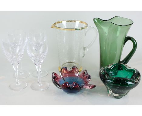 A collection of coloured glass tableware including molar vase, bubble glass jar, goblets, etc