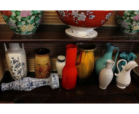 A collection of ten 20th century ceramic and glass vases and jugs including a Poole Pottery vase and an orange glass jug, 30c