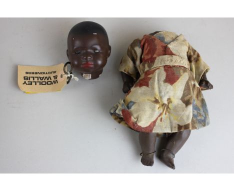 A Heubach Köppelsdorf bisque headed black doll (3994410) with sleeping eyes, composite body and limbs, 23cm, (a/f)