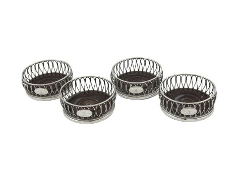 A SET OF FOUR IRISH GEORGIAN SILVER WIRE FRAMED DECANTER COASTERS, Dublin 1803, mark of James Scott, with turned timber bases