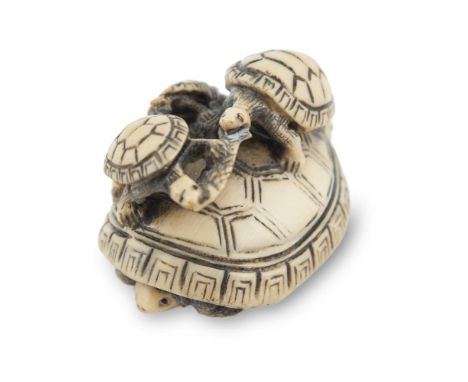 A 19TH CENTURY JAPANESE CARVED IVORY NETSUKE TORTOISE GROUP, depicting a fight over a fish on the back of a parent, signed. 4