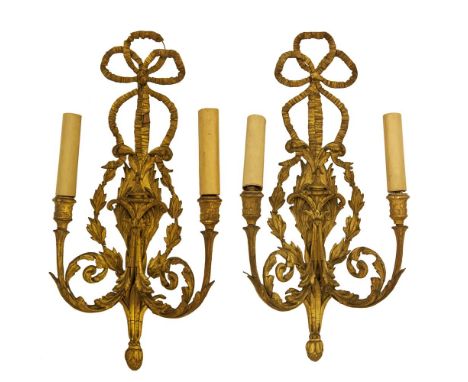 A PAIR OF 19TH CENTURY CARVED GILTWOOD, PLASTER AND GESSO TWO LIGHT WALL SCONCES, with surmounted ribbon ties above a central
