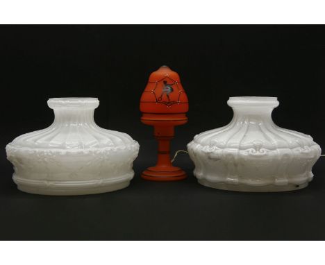 Two opaline glass light shades, together with an orange glass table lamp decorated with dancers