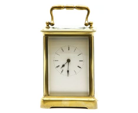 A large early 20th century Continental brass carriage clock, the white enamel dial with Roman numerals, 17.5cm high to the to