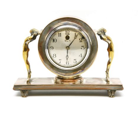 A Smith's electric clock in a copper and brass case, with a pair of naked female figures, 17cm high