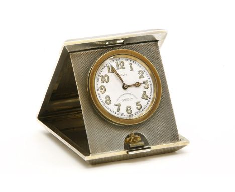 A silver and engine turned 'Pop Up' travel clock, 1936, Birmingham, the white dial with luminous numerals, 7.5cm wide x 9cm d