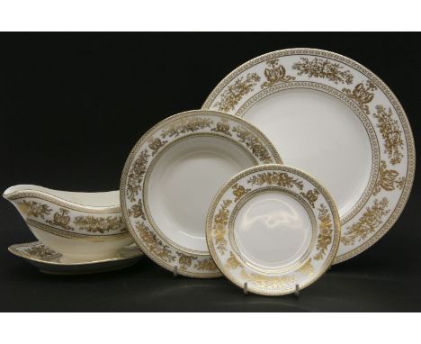 A quantity of Wedgwood 'Gold Columbia' dinner wares, to include dinner plates, side plates, bowls and serving dishes, etc.